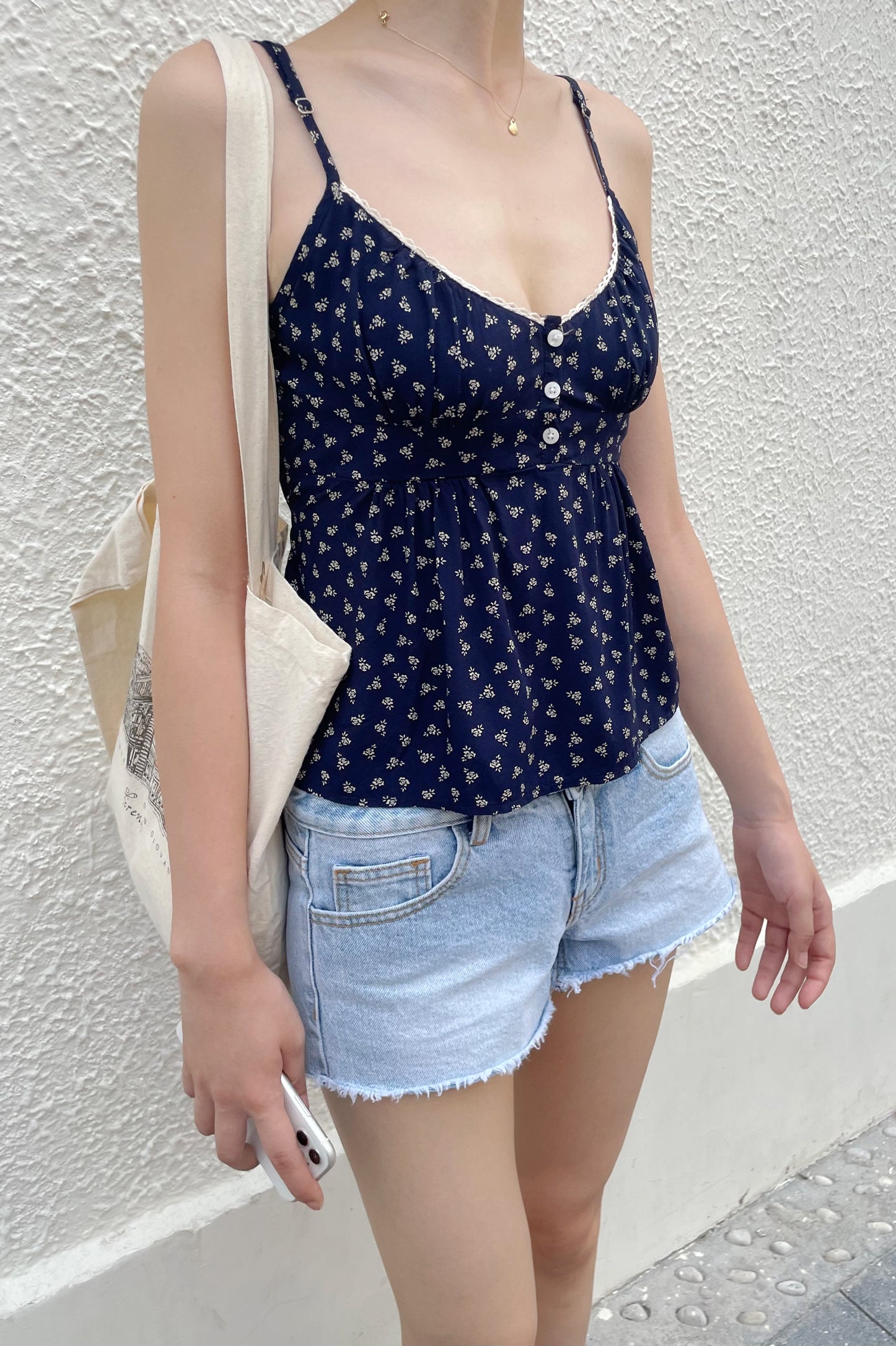 Hi! I'm currently looking for the Brandy Melville Tiffany Button Up tank.  It is so cute but I can not find the exact design for sale anywhere! Some  photos for reference: 